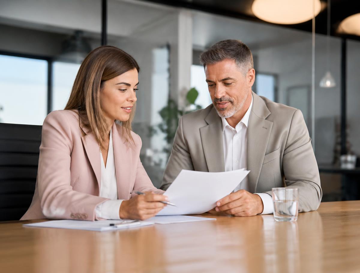 Colleagues reviewing hiring documents together